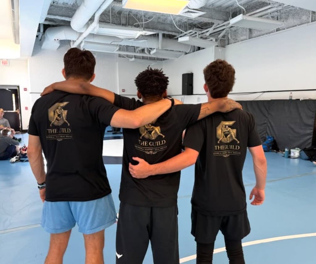 Guild coaches in branded apparel at practice