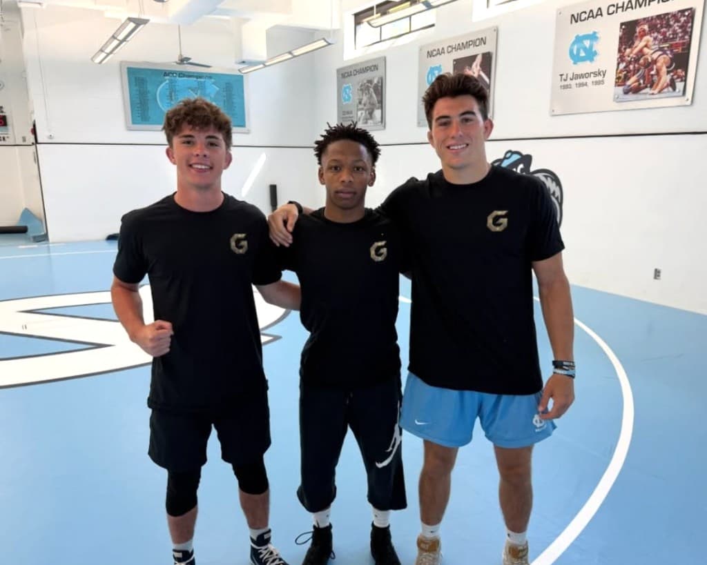 Guild coaches in a Division I wrestling room